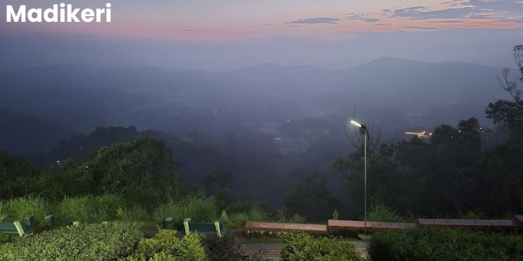 A scenic view of mountains from a bench, overlooking a lush valley in Madikeri, Karnataka, showcasing nature's beauty.